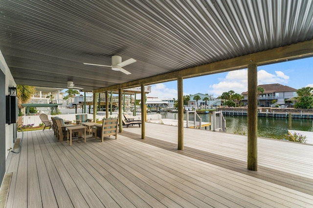 deck with ceiling fan, a dock, and a water view