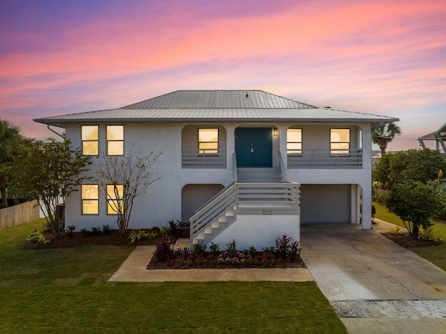 view of front of house with a garage and a lawn