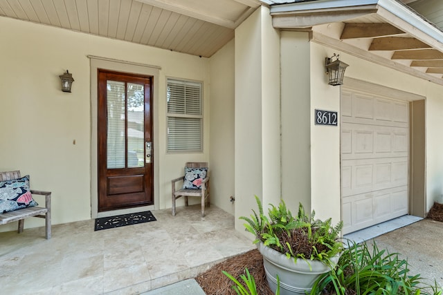 view of exterior entry with a garage