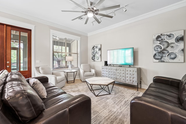 living room featuring ceiling fan, light wood-type flooring, crown molding, and a healthy amount of sunlight