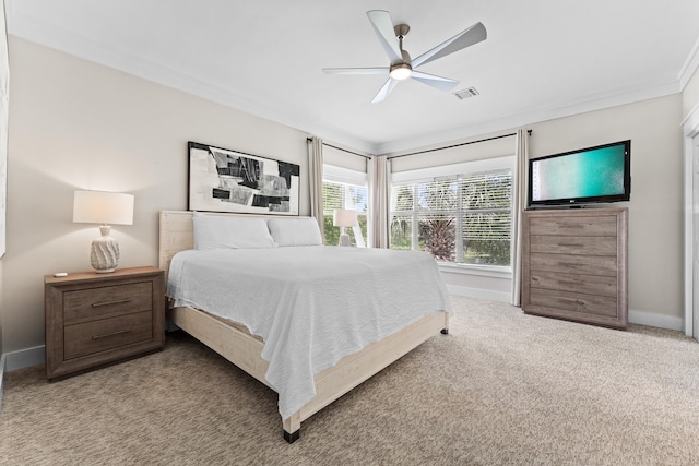 bedroom featuring ceiling fan, light colored carpet, and crown molding