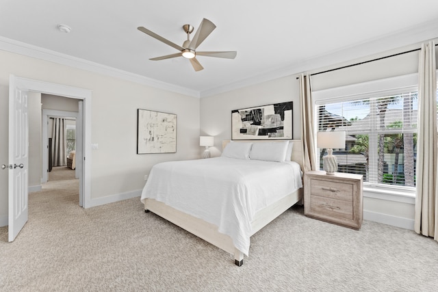 bedroom with ceiling fan, light colored carpet, and ornamental molding