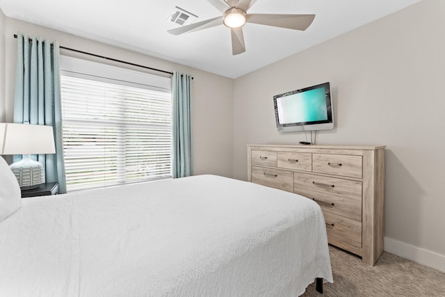 bedroom with ceiling fan and light colored carpet