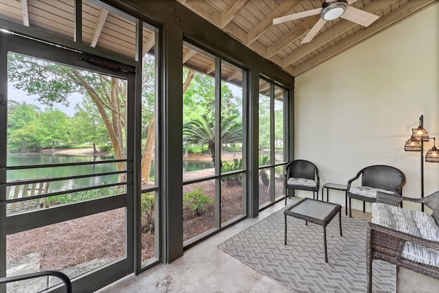 sunroom / solarium with a water view, wood ceiling, lofted ceiling with beams, and ceiling fan