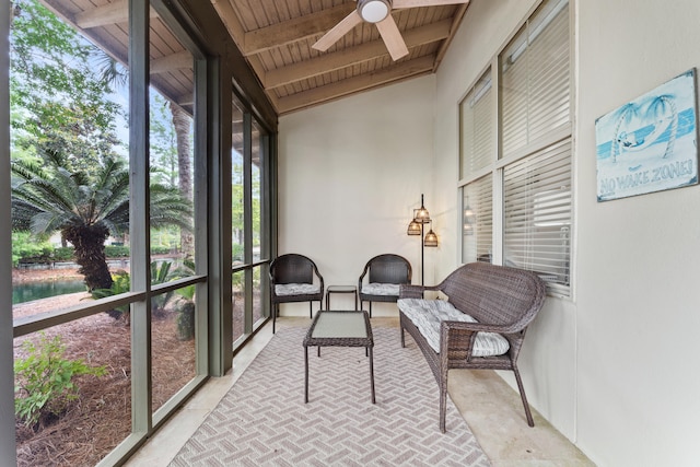 sunroom / solarium featuring lofted ceiling with beams, ceiling fan, and wooden ceiling