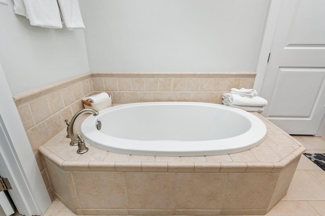 bathroom featuring tile patterned floors and a relaxing tiled tub