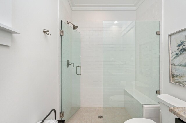 bathroom featuring toilet, an enclosed shower, and vanity