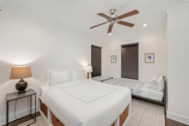 bedroom featuring ceiling fan, hardwood / wood-style flooring, and crown molding