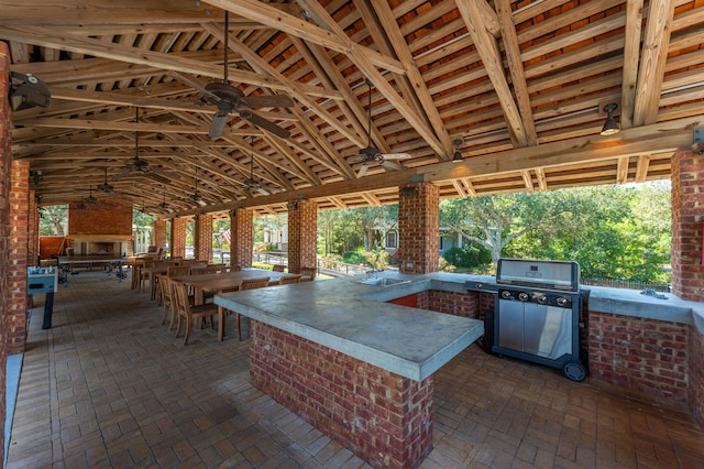 view of patio featuring area for grilling, sink, and ceiling fan