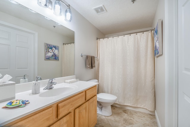 bathroom featuring tile patterned flooring, toilet, curtained shower, vanity, and a textured ceiling