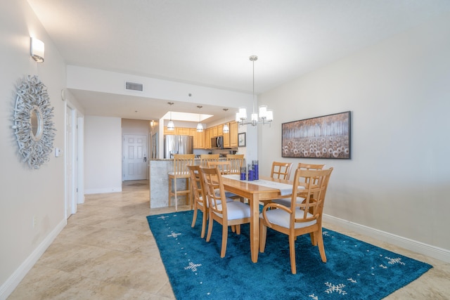 dining space with an inviting chandelier