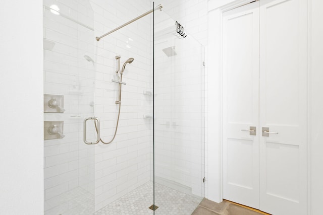 bathroom featuring a shower with shower door