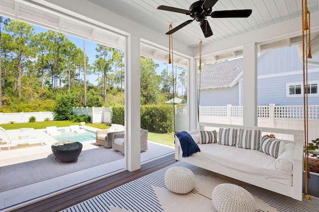 sunroom featuring ceiling fan