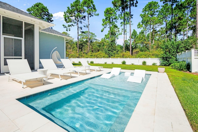 view of swimming pool featuring a sunroom and a patio area