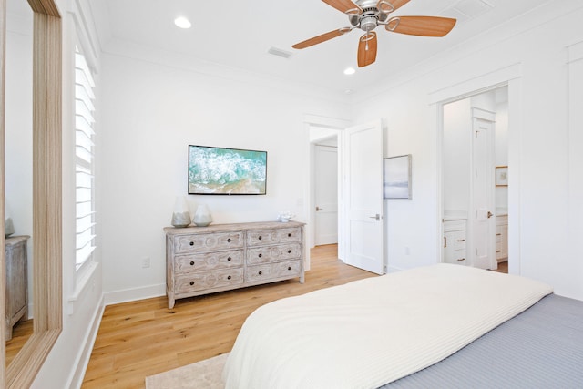 bedroom with ceiling fan, light hardwood / wood-style flooring, connected bathroom, and crown molding