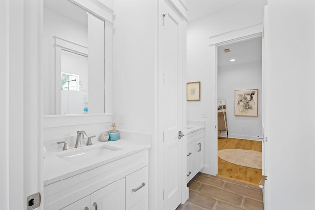 bathroom with vanity and hardwood / wood-style flooring