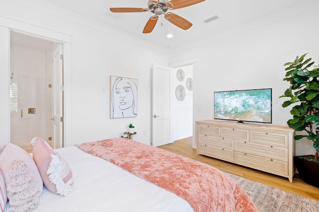 bedroom featuring ceiling fan, light hardwood / wood-style flooring, ensuite bath, and ornamental molding