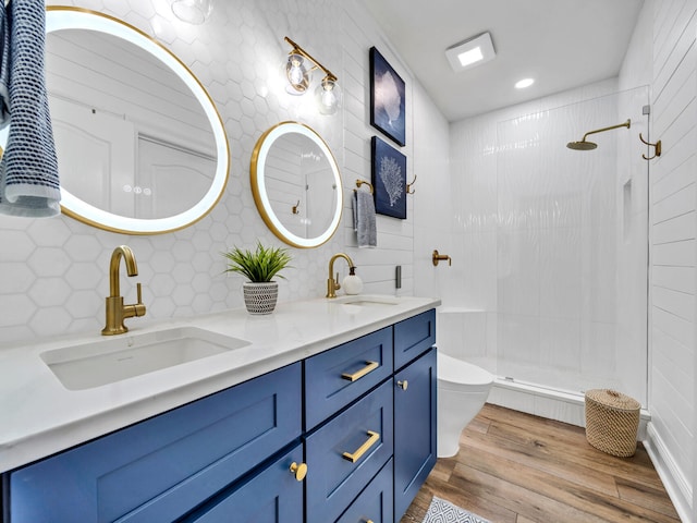 bathroom with decorative backsplash, toilet, a shower with shower door, wood-type flooring, and vanity