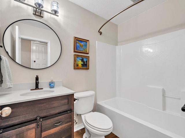 full bathroom with a textured ceiling, hardwood / wood-style flooring, toilet, shower / bathtub combination, and vanity