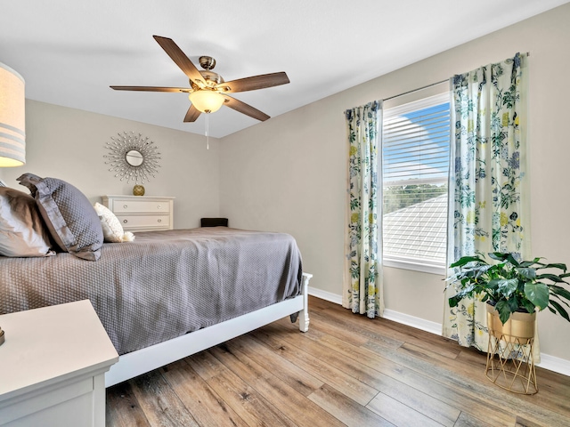 bedroom with hardwood / wood-style flooring and ceiling fan