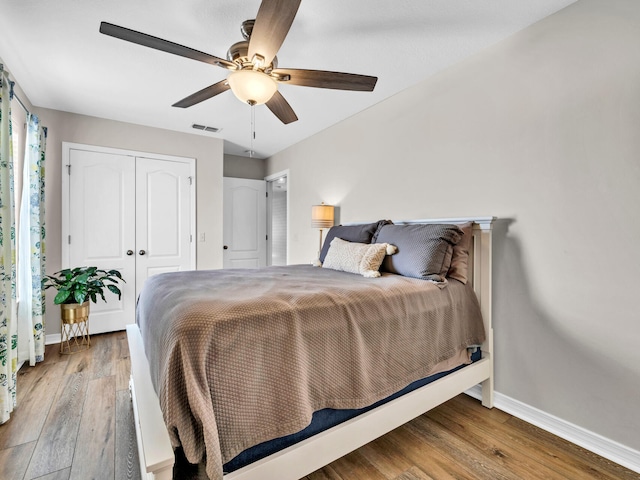 bedroom with a closet, ceiling fan, and wood-type flooring