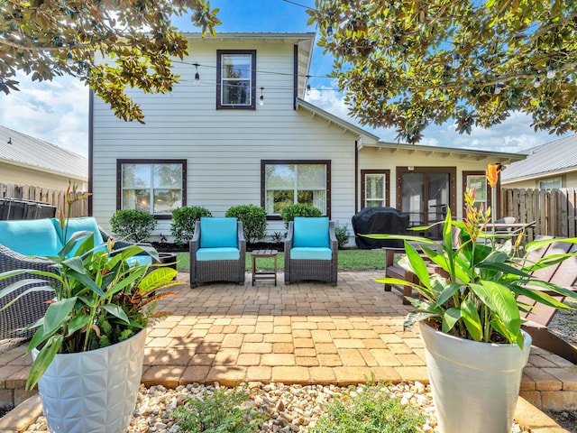 rear view of property with a patio area and a sunroom