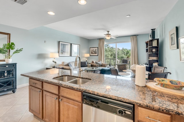 kitchen with ceiling fan, light stone counters, light tile patterned floors, sink, and dishwasher