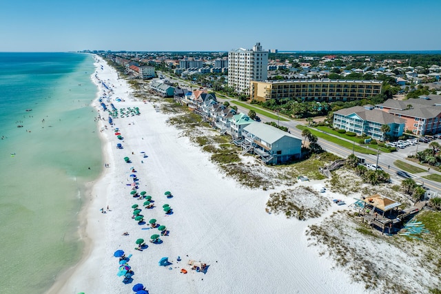 bird's eye view with a water view and a beach view