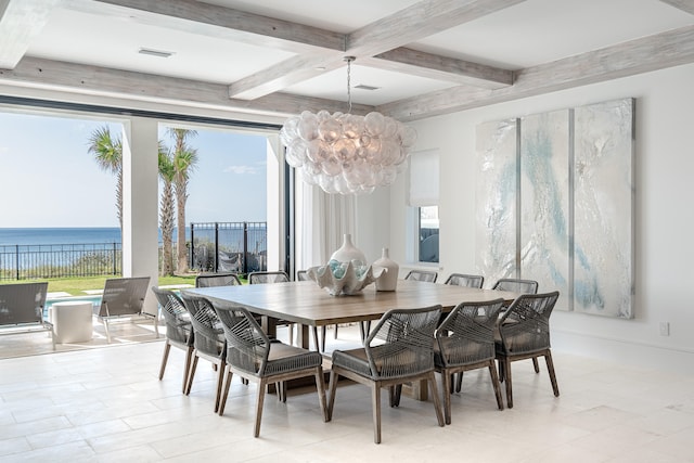 dining area with beamed ceiling, a notable chandelier, and a water view