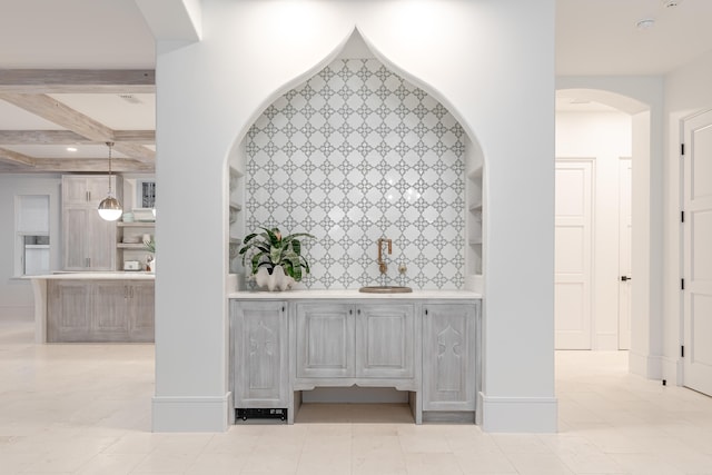 bar with pendant lighting, beamed ceiling, and light tile patterned flooring