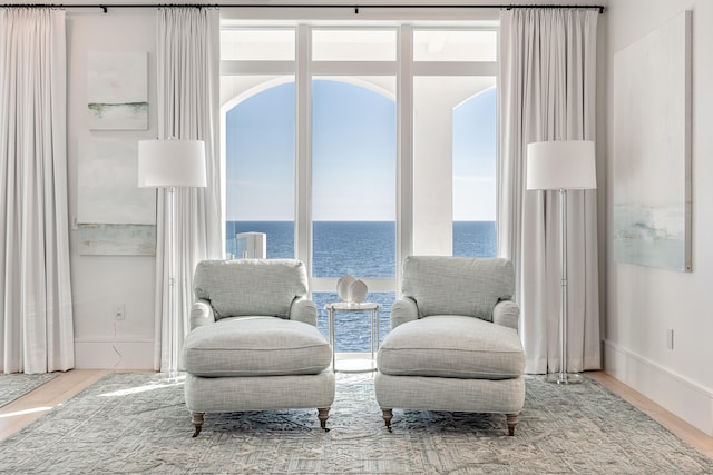 living area featuring a water view and hardwood / wood-style flooring