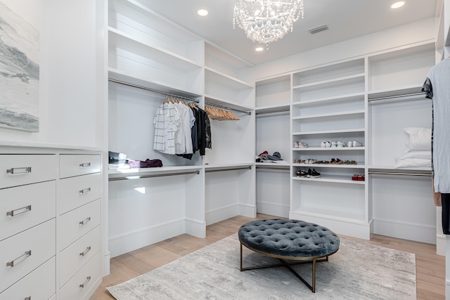 walk in closet with light wood-type flooring