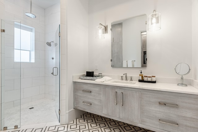 bathroom with tile patterned flooring, an enclosed shower, and vanity