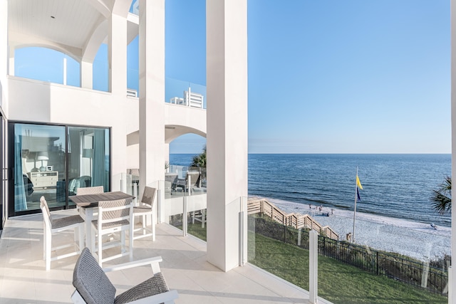 balcony featuring a water view and a patio area