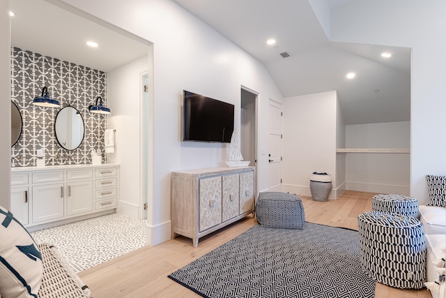 bedroom featuring lofted ceiling and light hardwood / wood-style floors