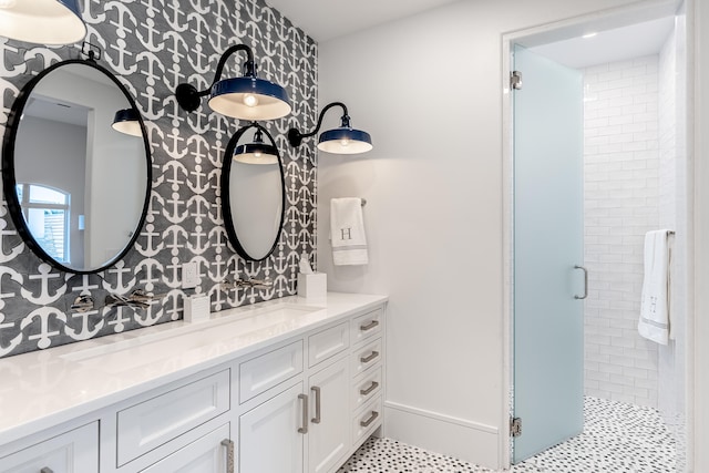 bathroom featuring tile patterned flooring, an enclosed shower, and vanity