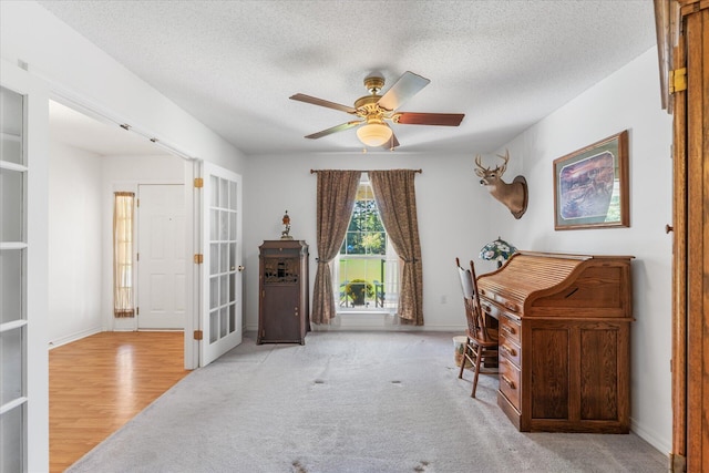 office space with ceiling fan, a textured ceiling, and light hardwood / wood-style flooring