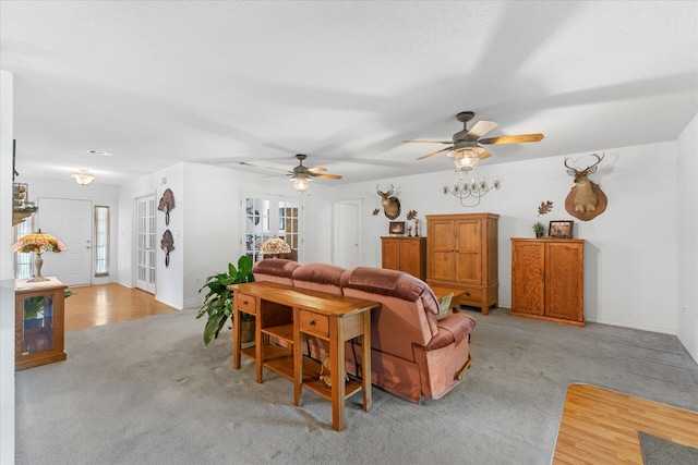 carpeted living room with ceiling fan and plenty of natural light