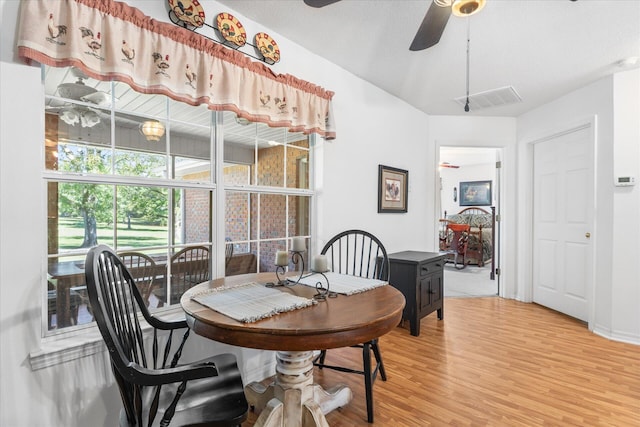 dining area with hardwood / wood-style flooring and ceiling fan