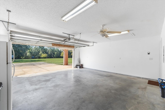 garage featuring ceiling fan, white refrigerator, and a garage door opener