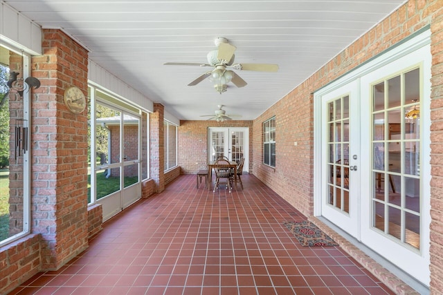 unfurnished sunroom with french doors and ceiling fan