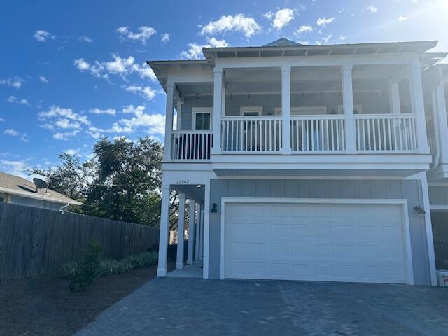 view of front of home with a garage and a balcony