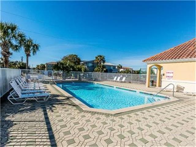 2076 Scenic Gulf Dr Unit 1013, Miramar Beach, FL 32550 - pool with fence and a patio area