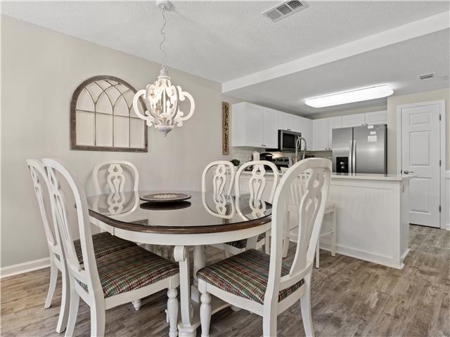 2076 Scenic Gulf Dr Unit 1013, Miramar Beach, FL 32550 - dining room with an inviting chandelier, light wood-style flooring, and visible vents