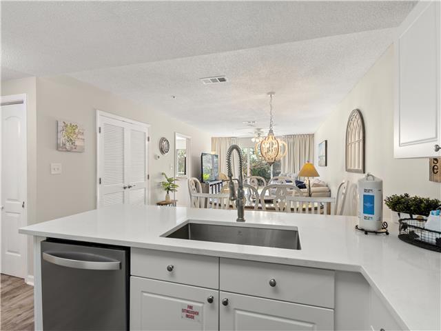 2076 Scenic Gulf Dr Unit 1013, Miramar Beach, FL 32550 - kitchen with a sink, dishwasher, light countertops, a textured ceiling, and visible vents