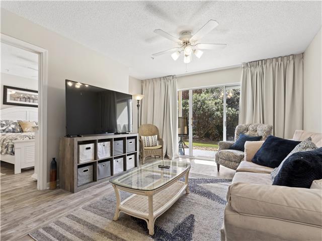 2076 Scenic Gulf Dr Unit 1013, Miramar Beach, FL 32550 - living room featuring a ceiling fan, a textured ceiling, and wood finished floors