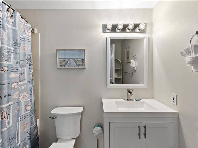 2076 Scenic Gulf Dr Unit 1013, Miramar Beach, FL 32550 - full bath with toilet, a shower with shower curtain, and vanity