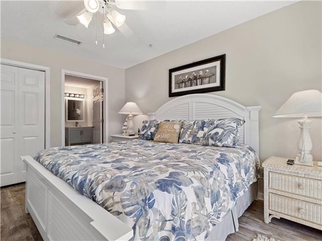 2076 Scenic Gulf Dr Unit 1013, Miramar Beach, FL 32550 - bedroom with ensuite bath, a ceiling fan, wood finished floors, visible vents, and a closet