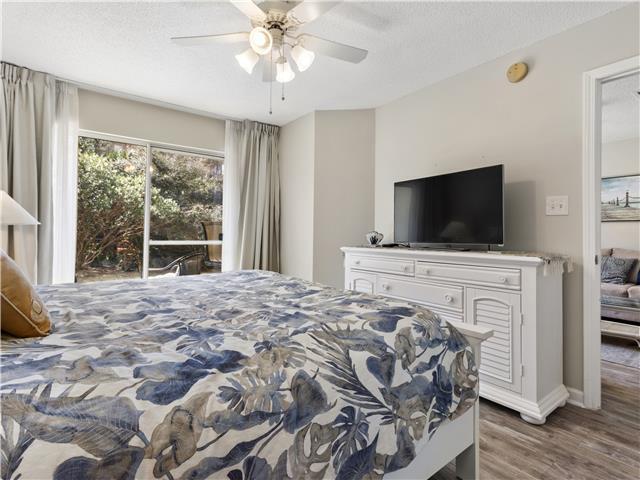 2076 Scenic Gulf Dr Unit 1013, Miramar Beach, FL 32550 - bedroom featuring baseboards, ceiling fan, and wood finished floors