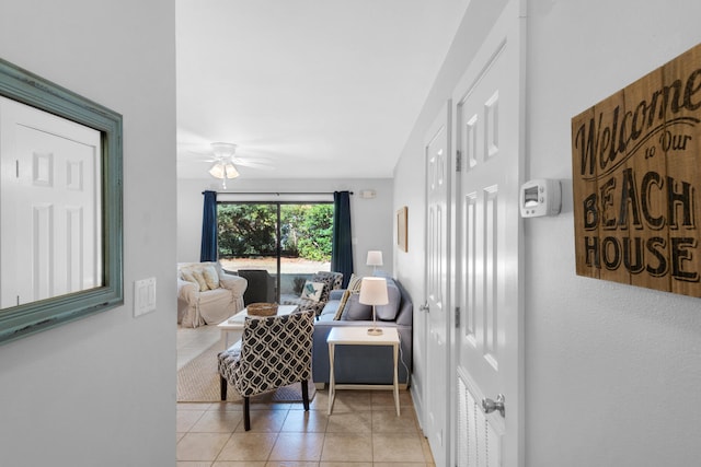 living area featuring ceiling fan and light tile patterned floors